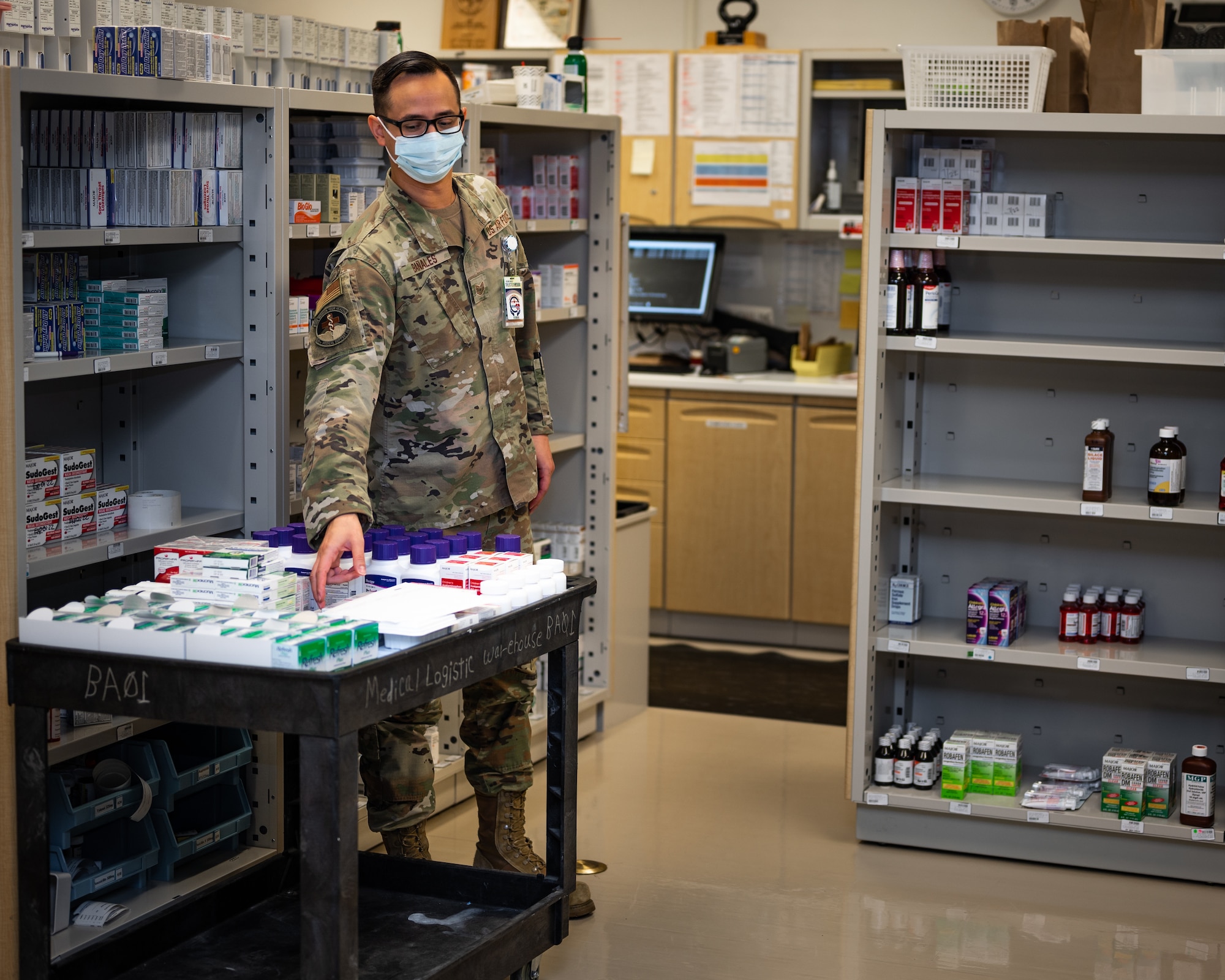 U.S. Air Force Tech. Sgt. Andrew Bañales, 18th Medical Support Squadron NCO in charge of pharmacy, takes inventory of medicine at Kadena Air Base, Japan, Sept. 1, 2021. The 18th MDSS is one of four squadrons that fall under the 18th Medical Group. (U.S. Air Force photo by Airman 1st Class Stephen Pulter)