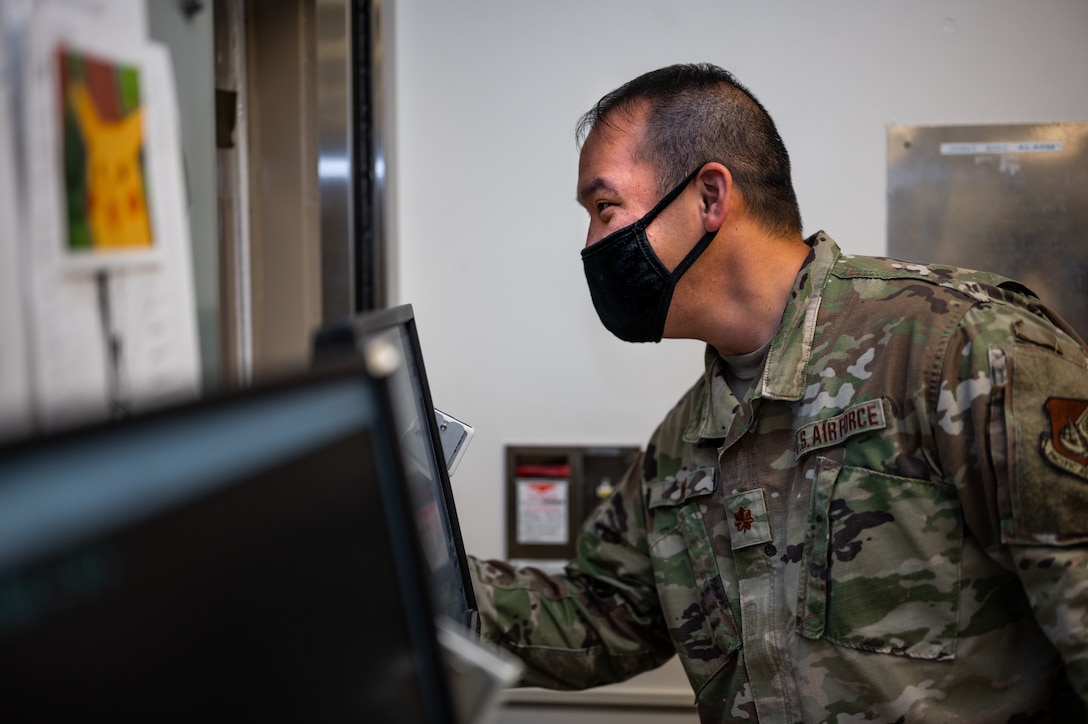 U.S. Air Force Maj. John Wu, 18th Medical Support Squadron NCO pharmacy flight commander, hands a patient their medication at Kadena Air Base, Japan, Sept. 1, 2021. The 18th Medical Group provides medical care to base and joint service personnel, seeing almost 500 patients daily. (U.S. Air Force photo by Airman 1st Class Stephen Pulter)