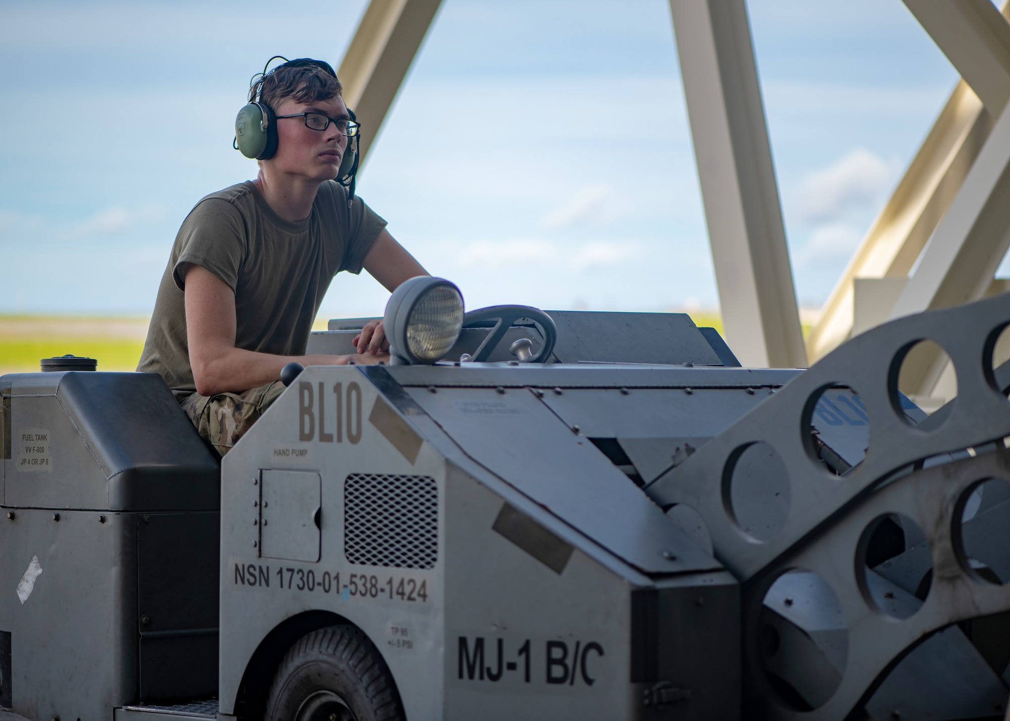 U.S. Air Force Airman 1st Class Logan Millman, 44th Aircraft Maintenance Unit Weapons load crew member, operates machinery during weapons load training.