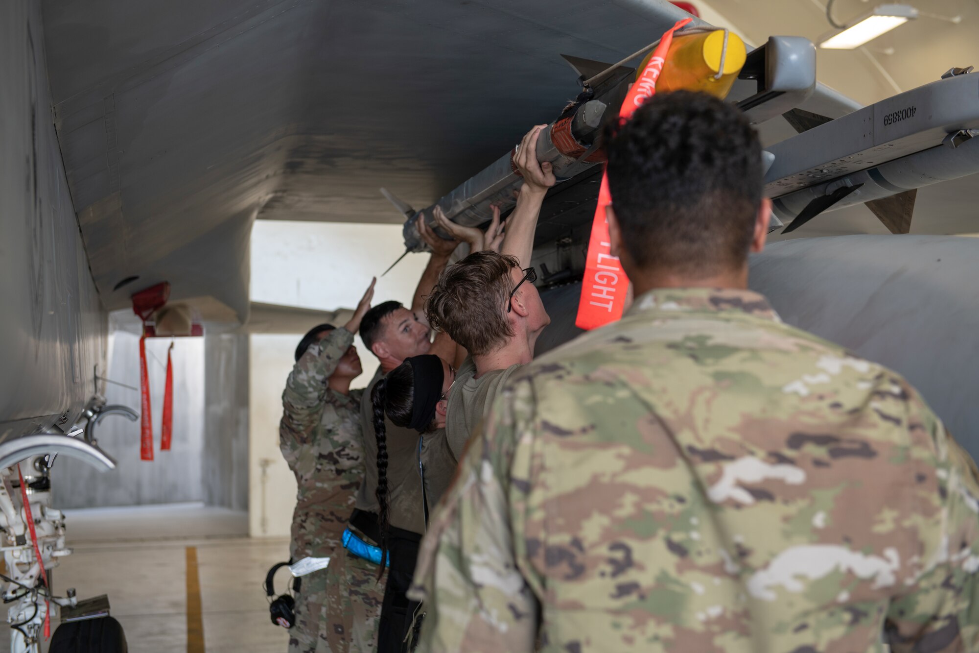 U.S. Air Force Airmen from the 44th Aircraft Maintenance Unit load a missile onto an F-15C Eagle during weapons load training