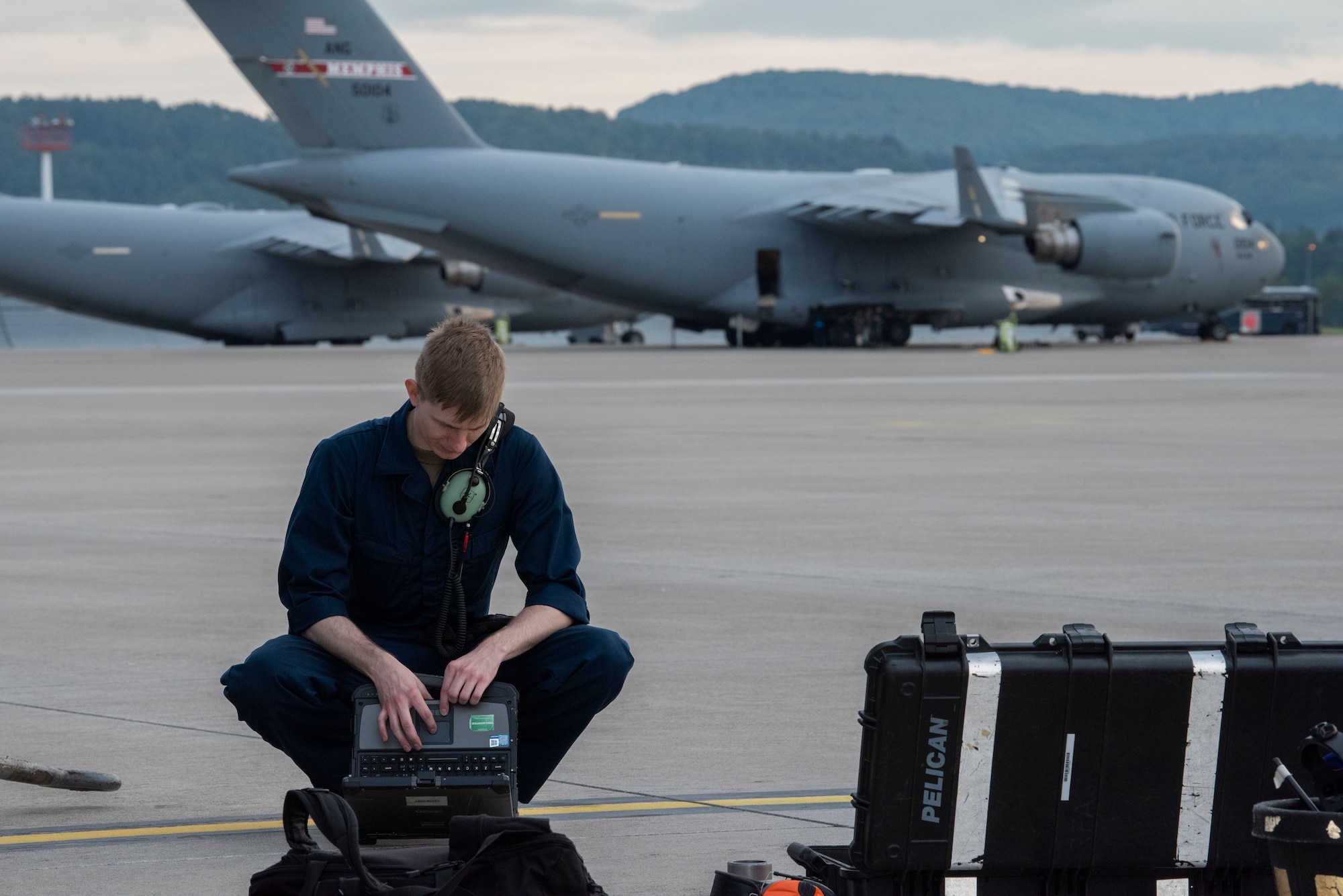 Airman goes through tools on flightline.