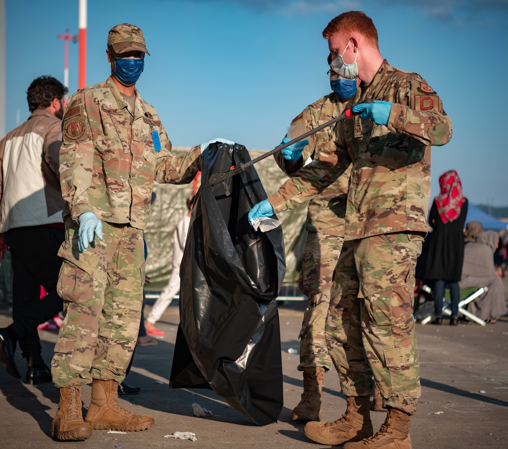 Airmen gather trash.