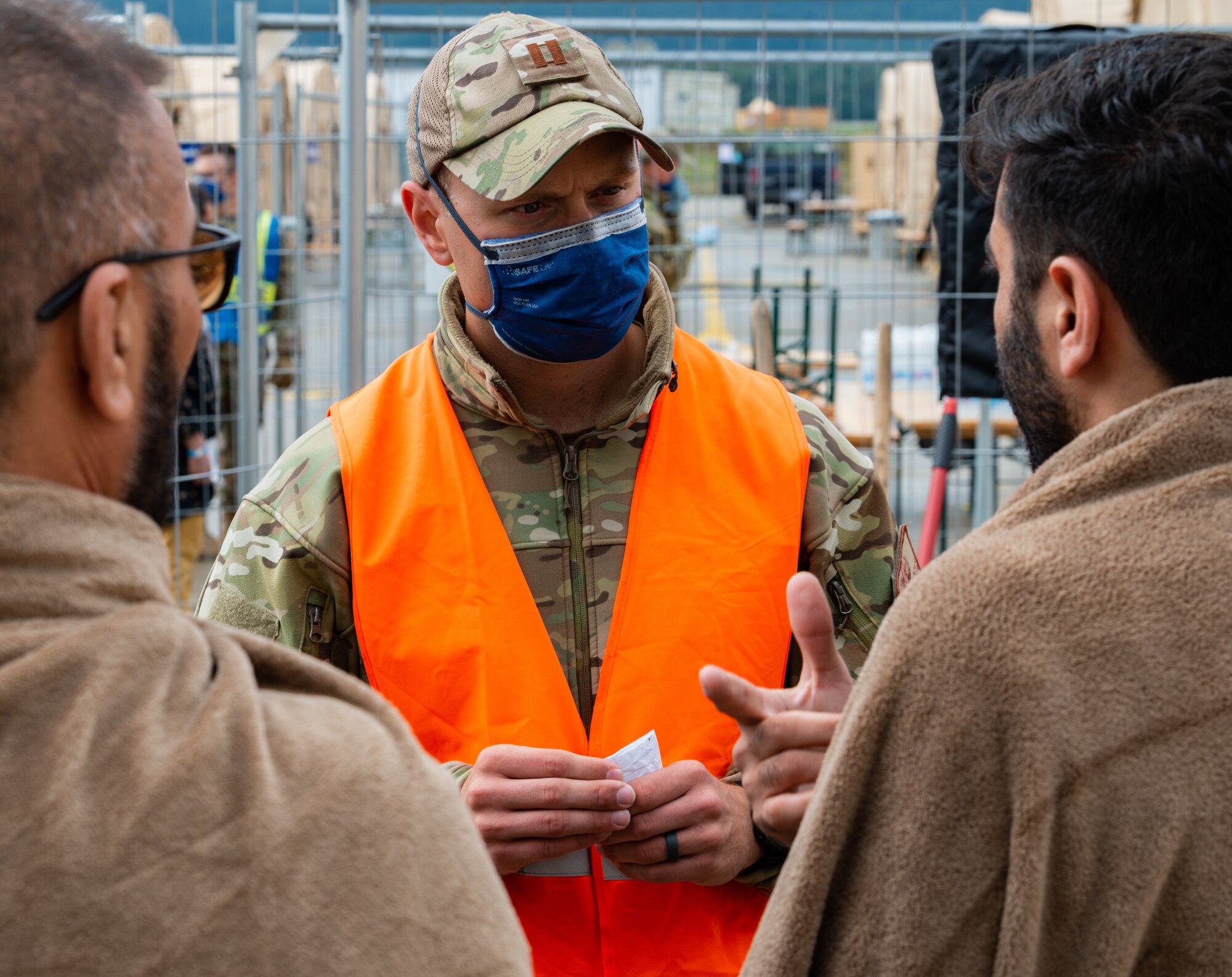 An Airman speaks with evacuees.