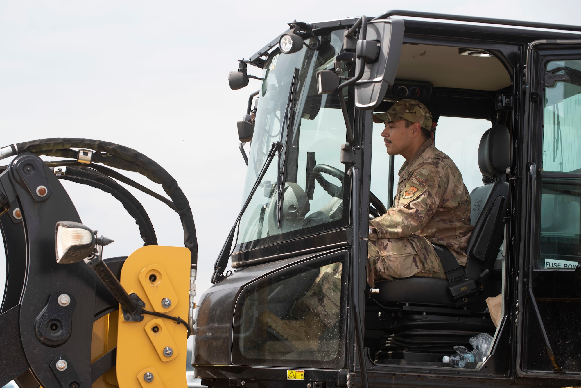 Airman drives construction vehicle.