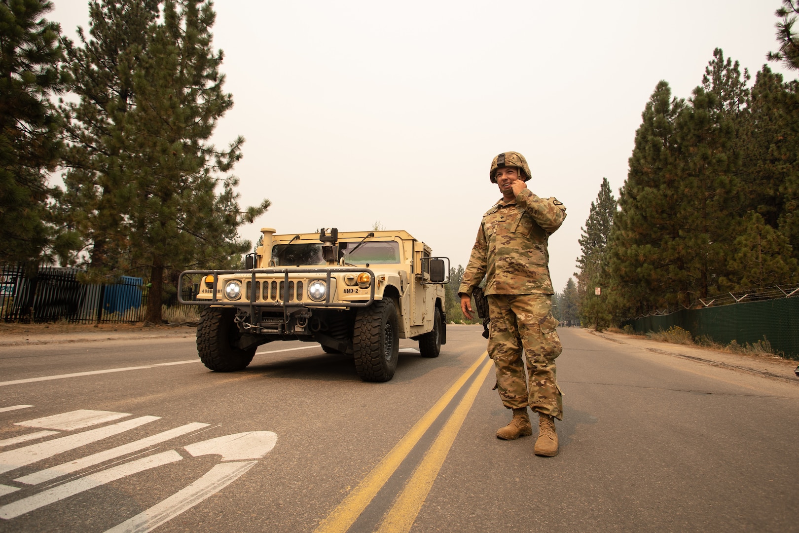 U.S. Army Spc. Dace Taylor, from the California Army National Guard’s 270th Military Police Company, talks to another Soldier Sept. 1, 2021, in South Lake Tahoe, California, as the Caldor Fire encroaches on the evacuated city. Cal Guard activated 150 military police Aug. 30 to support the California Highway Patrol with checkpoints at hard closures while the area was evacuated.