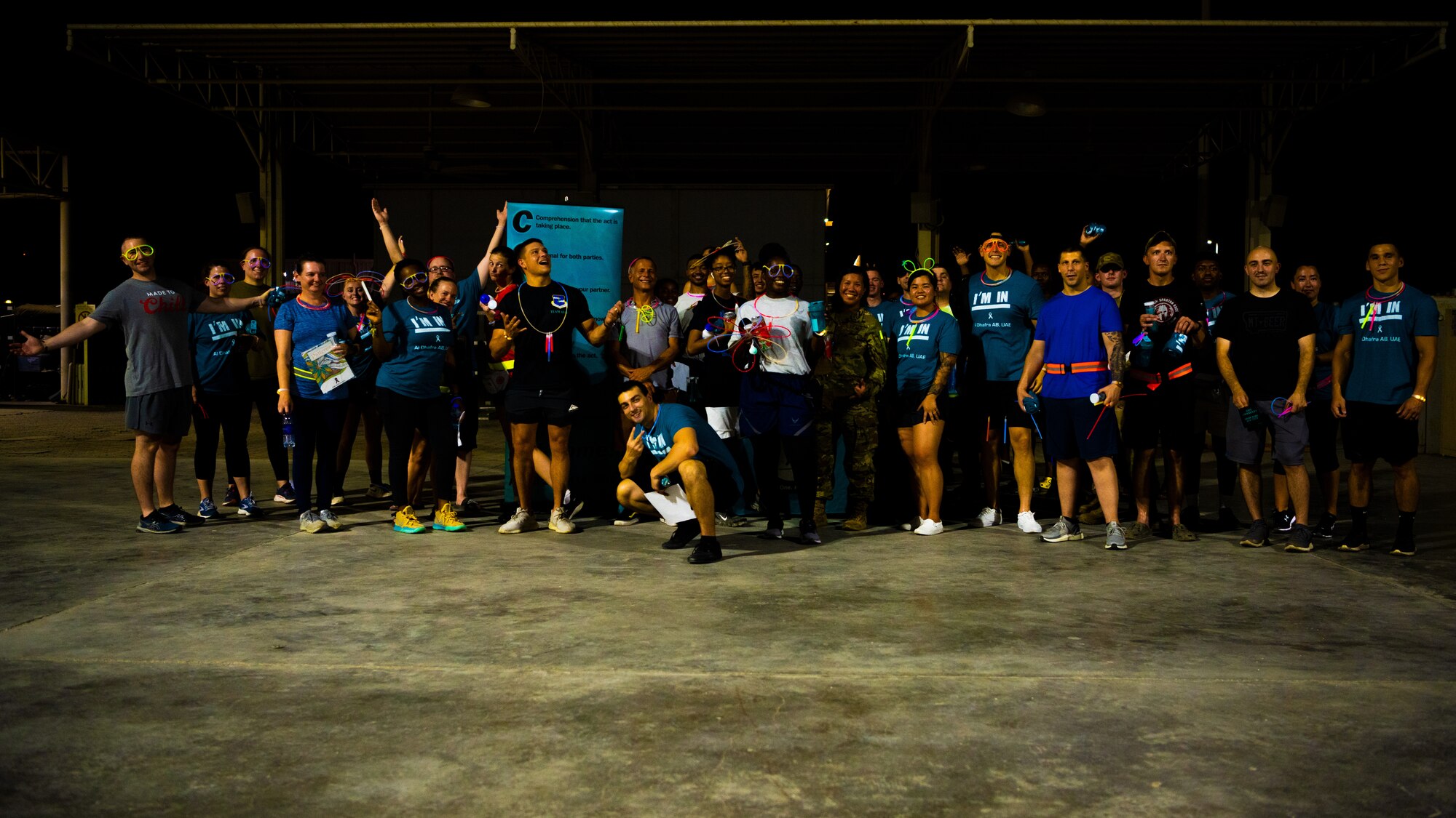 U.S. Army and Air Force service members participate in Al Dhafra Air Base’s first Lighting and Safety Glow Walk, Aug. 25, 2021. Members and volunteers of the 380th Air Expeditionary Wing’s Sexual Assault Prevention & Response program hosted the event to allow the community to identify potentially unsafe locations around base.