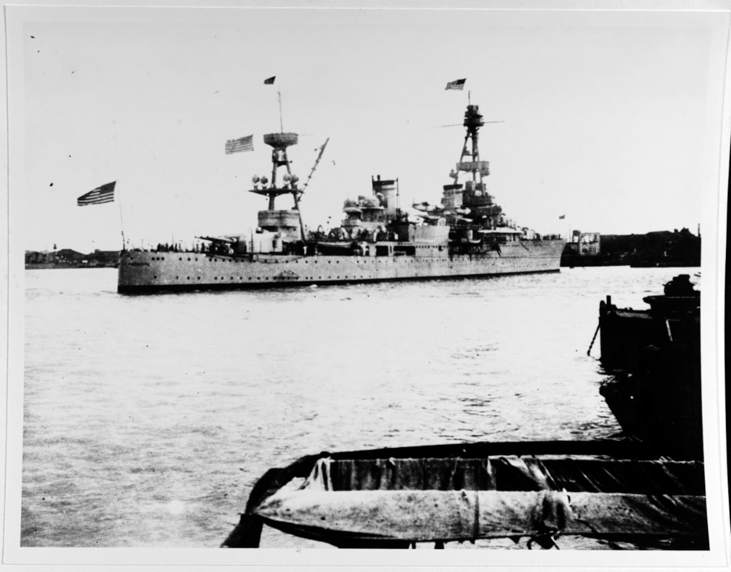 USS Augusta (CA-31). View taken off the “Bund” at Shanghai, China, being moved into position at the foot of "Man of War" row, during the Sino-Japanese hostilities there, 18 August 1937. Note American flags at fore, gaff, and flagstaff. Ship was then the flagship of Admiral H.E. Yarnell, USN, CINCAF (NH 84774).
