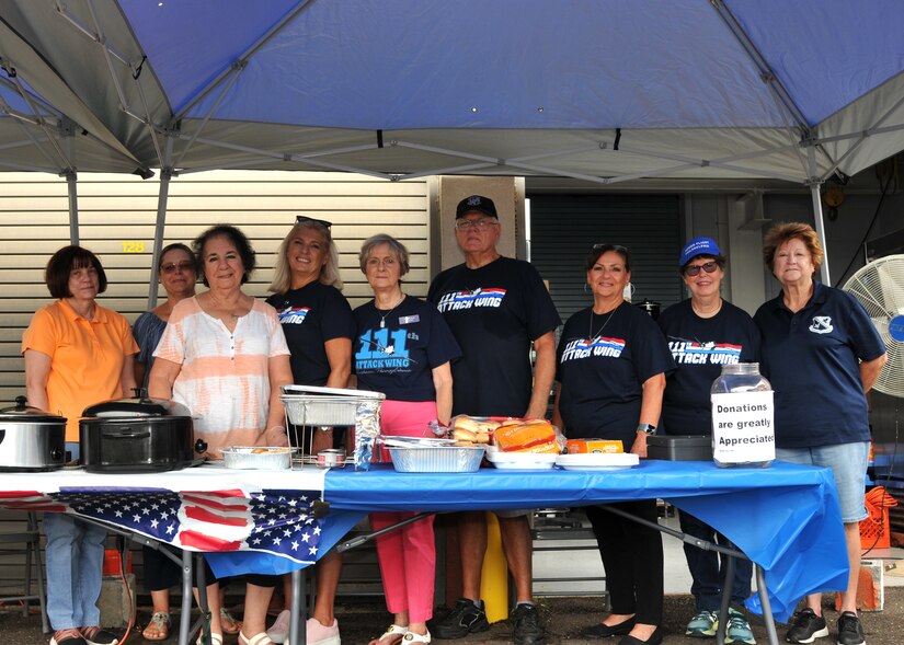 111th Attack Wing's Airman and Family Readiness Group program manager, Anna Richar, poses for a photo with members of the 111th’s Key Spouse Volunteer Group during the FRG Burger Burn held August 19th at Biddle Air National Guard Base in Horsham, Pennsylvania.  Richar often credits her team of volunteers for the success in of the 111th's award-winning family readiness program. (U.S. Air National Guard photo by Tech. Sgt. Tyrone G Mitchell)