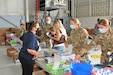 Anna Richar, 111th Attack Wing’s Airman & Family Readiness Group program manager, assists Lt. Col. Angela McDonough of the 111th Medical Group during the Backpack Brigade,  an annual school supply collection and distribution campaign, held at Biddle Air National Guard Base in Horsham, Pennsylvania, August 8, 2021. 111th ATKW’s Family Readiness Group has distributed more than 300 backpacks to military children to offset the cost of school expenses for military families. (U.S. Air National Guard photo by Tech. Sgt. Tyrone G Mitchell)