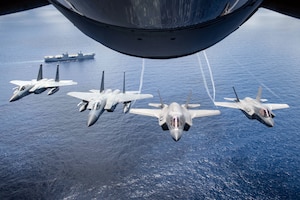 Two U.S. Marine Attack Squadron 211 F-35B Lightning IIs and two U.S. Air Force F-15 Eagles assigned to the 67th Fighter Squadron, fly over United Kingdom aircraft carrier HMS Queen Elizabeth over the west Indo-Pacific region