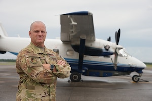 Col. Jason Grandy, 919th Special Operations Wing commander, stands in front of a C-145 Combat Coyote at Duke Field, Florida, July 20, 2021. (U.S. Air Force Photo by Senior Airman Dylan Gentile)
