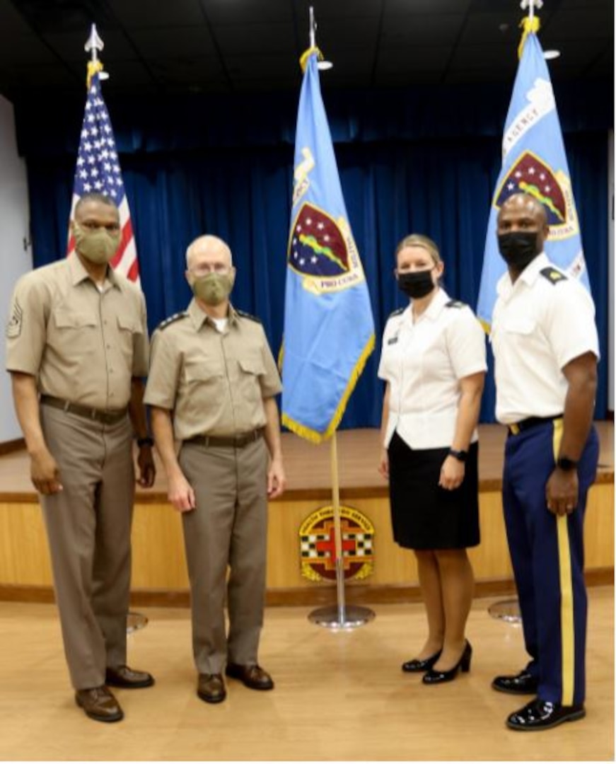 DHA Director, Lieutenant General Ronald J. Place, DHA Senior Enlisted Leader, Command Sgt. Major Michael Gragg, Low Country Market leadership, Col. Julie Freeman, and Command Sgt. Major Charles Robinson stand in front of the new DHA and Low Country Colors, September 2.