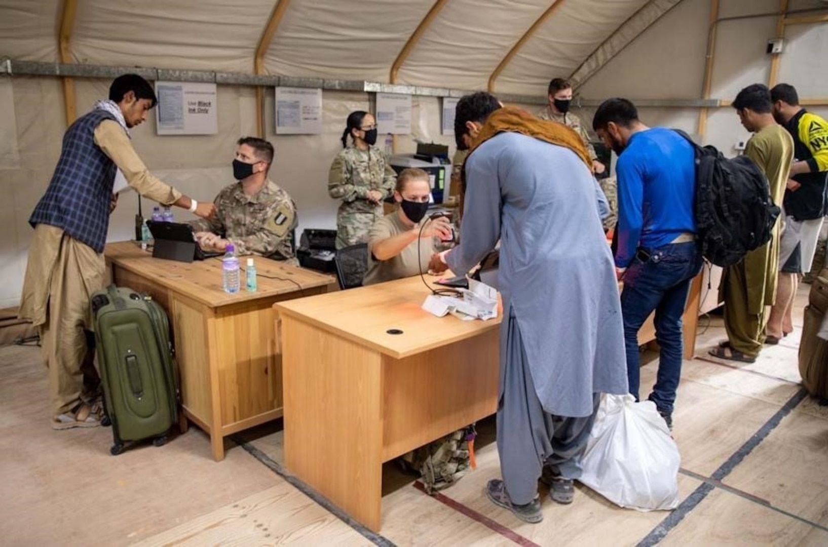 U.S. Army Central Soldiers welcome and assist Afghan evacuees as they arrive and process through locations in Kuwait. DLA Troop Support’s Clothing and Textiles supply chain expedited shipping of approximately 5,000 disaster blankets and 90 general purpose tents, which hold up to 10 people each, were delivered to Camp Arifjan September 3, 2021.