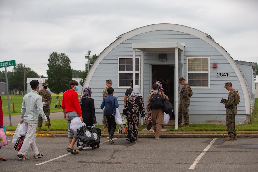 Civilians line up to enter a shelter.