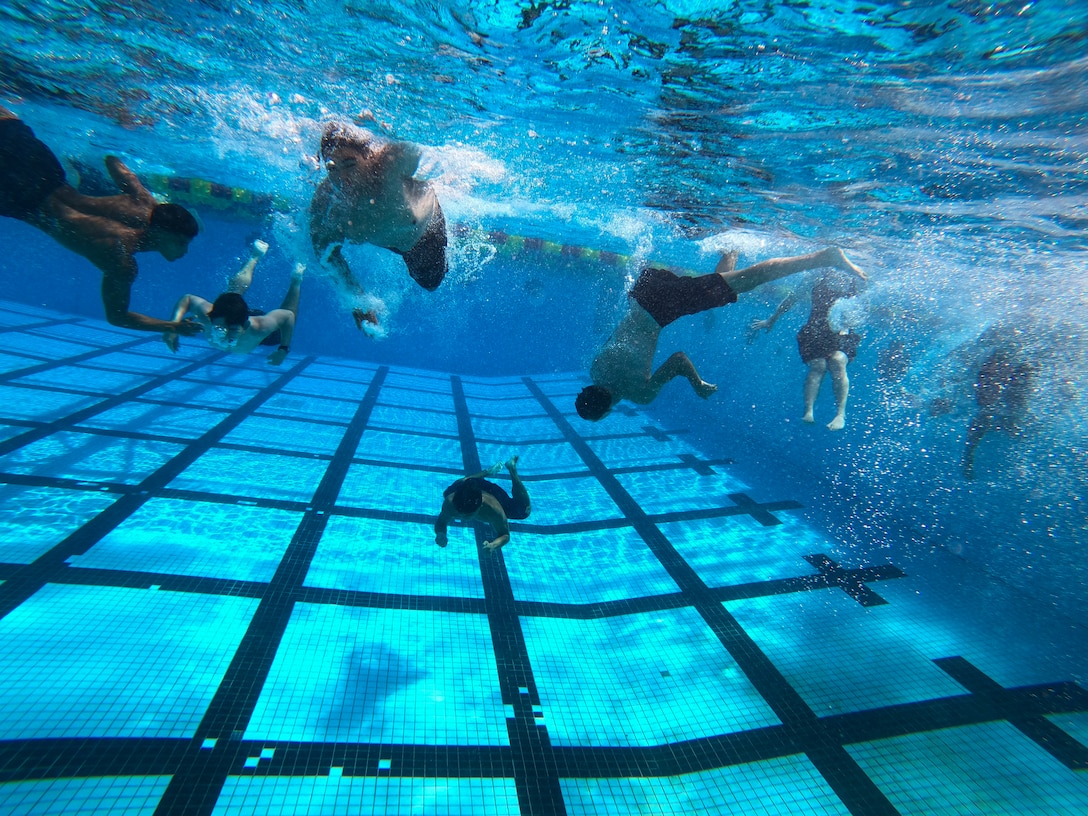 U.S. Naval Reserve Officer Training Corps midshipmen with the University of Hawaii at Manoa, swim during an ROTC swimming exercise aboard Marine Corps Base Hawaii, Aug. 15, 2021. This training event was part of the New Student Orientation which serves to standardize midshipmen across the board, providing a baseline level of knowledge on military bearing, presentation, customs, courtesies, and leadership. UH Manoa NROTC staff partnered with MCBH to train aboard the installation and prepare the midshipmen for future careers in the naval service as commissioned officers. (U.S. Marine Corps photo by Lance Cpl. Samantha Sanchez)