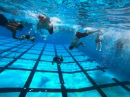 U.S. Naval Reserve Officer Training Corps midshipmen with the University of Hawaii at Manoa, swim during an ROTC swimming exercise aboard Marine Corps Base Hawaii, Aug. 15, 2021. This training event was part of the New Student Orientation which serves to standardize midshipmen across the board, providing a baseline level of knowledge on military bearing, presentation, customs, courtesies, and leadership. UH Manoa NROTC staff partnered with MCBH to train aboard the installation and prepare the midshipmen for future careers in the naval service as commissioned officers. (U.S. Marine Corps photo by Lance Cpl. Samantha Sanchez)