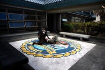 A U.S. Marine from the Provost Marshal Office, Marine Corps Base Hawaii, assesses a simulated victim’s condition during an active attacker scenario, MCBH, Aug. 24, 2021. The purpose of this training was to produce readiness by setting conditions, which enable our first responders to deploy at a moment’s notice. (U.S. Marine Corps photo by Pfc. Christian Tofteroo)
