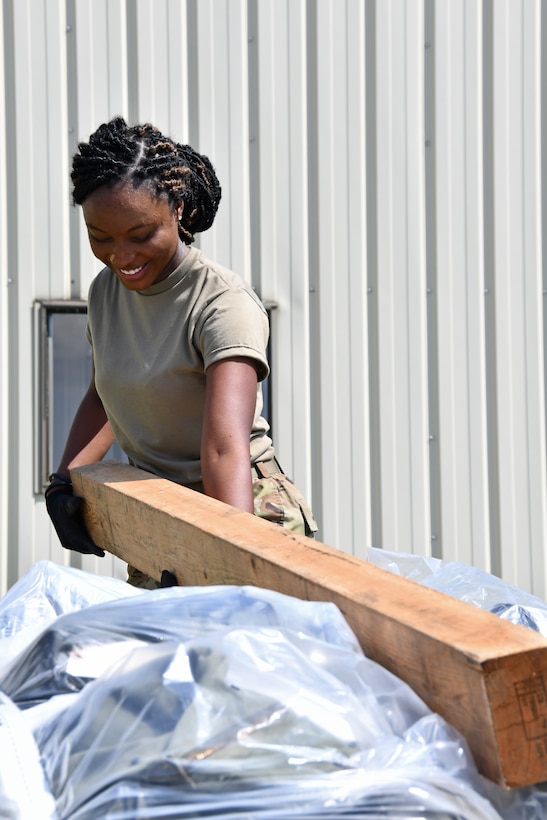 Airman 1st Class Jennifer Joseph, a materials handler with the 104th Logistics Readiness Squadron, secures a pallet during a mobility exercise August 13, 2021, at Barnes Air National Guard Base, Massachusetts. Mobility exercises test the wing's ability to rapidly deploy aircraft, equipment, personnel and cargo. (U.S. Air National Guard photo by Staff Sgt. Hanna Smith)