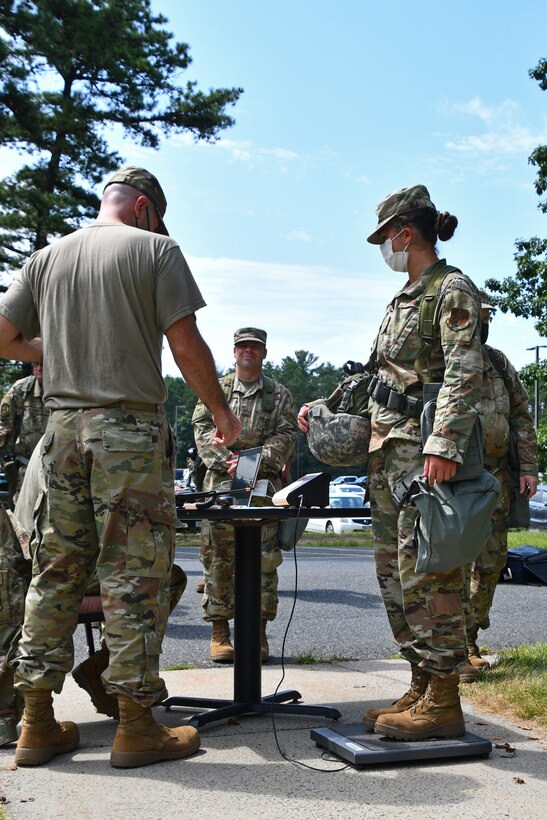 104th Fighter Wing Airmen get weighed prior to processing through a Pre-Deployment Function line during a mobility exercise August 14, 2021, at Barnes Air National Guard Base, Massachusetts. Mobility exercises test the wing's ability to rapidly deploy aircraft, equipment, personnel and cargo. (U.S. Air National Guard photo by Staff Sgt. Hanna Smith)