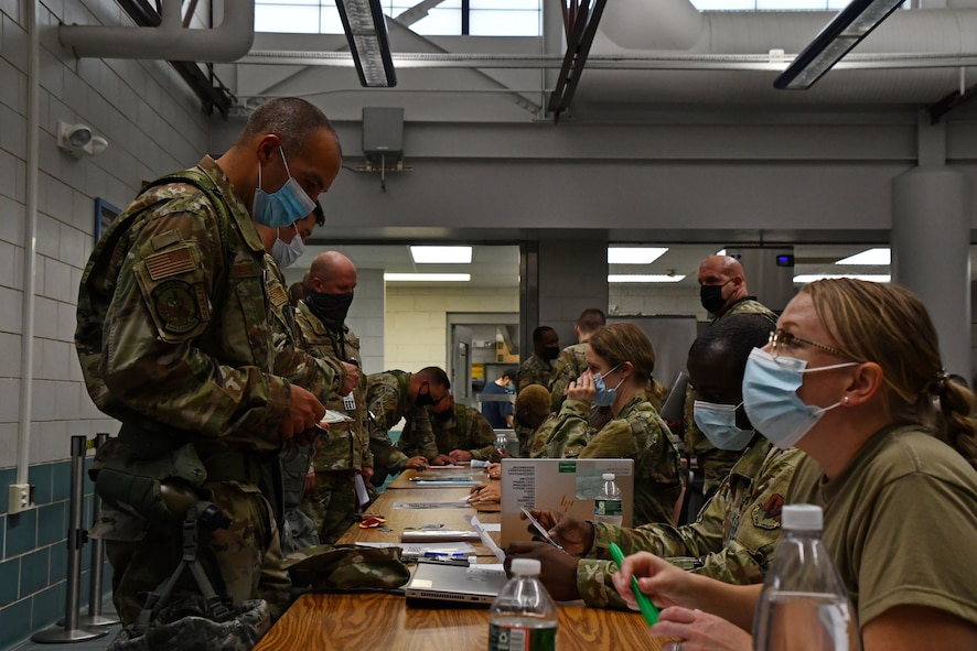 104th Fighter Wing Airmen process through a Pre-Deployment Function line as part of a mobility exercise August 14, 2021, at Barnes Air National Guard Base, Massachusetts. Mobility exercises test the wing's ability to rapidly deploy aircraft, equipment, personnel and cargo. (U.S. Air National Guard photo by Staff Sgt. Hanna Smith)