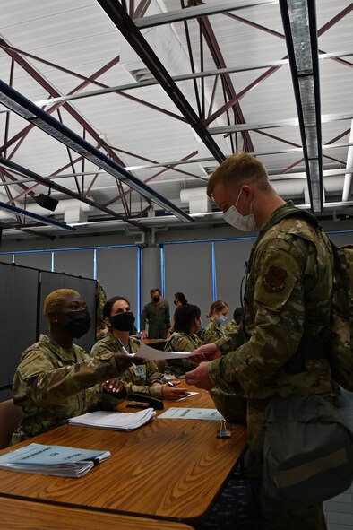 104th Fighter Wing Airmen process through a  Pre-Deployment Function line as part of a mobility exercise August 14, 2021, at Barnes Air National Guard Base, Massachusetts. Mobility exercises test the wing's ability to rapidly deploy aircraft, equipment, personnel and cargo. (U.S. Air National Guard photo by Staff Sgt. Hanna Smith)
