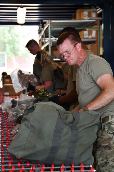 Master Sgt. Matthew Borges, a materials handaler with the 102nd Intelligence Wing, packs a mobility bag during a mobility exercise August 13, 2021, at Barnes Air National Guard Base, Massachusetts. August 13, 2021, at Barnes Air National Guard Base, Massachusetts. Mobility exercises test the wing's ability to rapidly deploy aircraft, equipment, personnel and cargo. (U.S. Air National Guard photo by Staff Sgt. Hanna Smith)