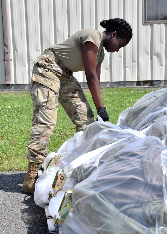 Airman 1st Class Abena Koranteng, 104th Logistics Readiness Squadron materials handler, secures a pallet during a mobility exercise August 13, 2021, at Barnes Air National Guard Base, Massachusetts. The exercise was in progress August 9-15 and served as a practice opportunity for members to evaluate capabilities of their squadrons in the event of a base-wide mobilization. (U.S. Air National Guard photo by Staff Sgt. Sara Kolinski)