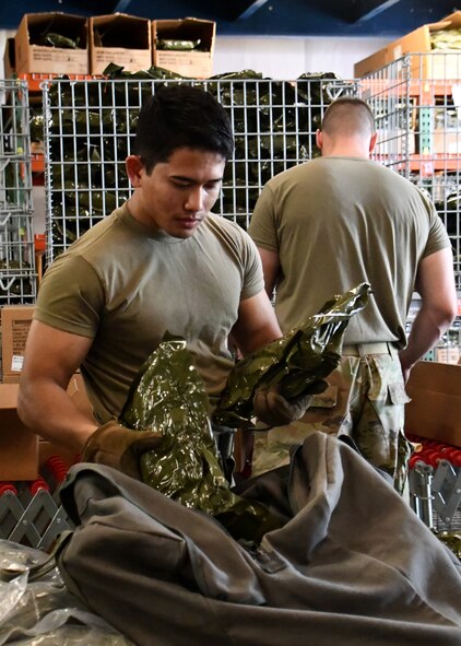 Senior Airman Rithy Panha Von Chhay, 102nd Logistics Readiness Squadron material manager, assists the 104 LRS with processing mobility bags during a mobility exercise August 13, 2021, at Barnes Air National Guard Base, Massachusetts. The exercise was in progress August 9-15 and served as a practice opportunity for members to evaluate capabilities of their squadrons in the event of a base-wide mobilization. (U.S. Air National Guard photo by Staff Sgt. Sara Kolinski)