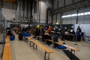 passengers wait to be processed through hangar 5.