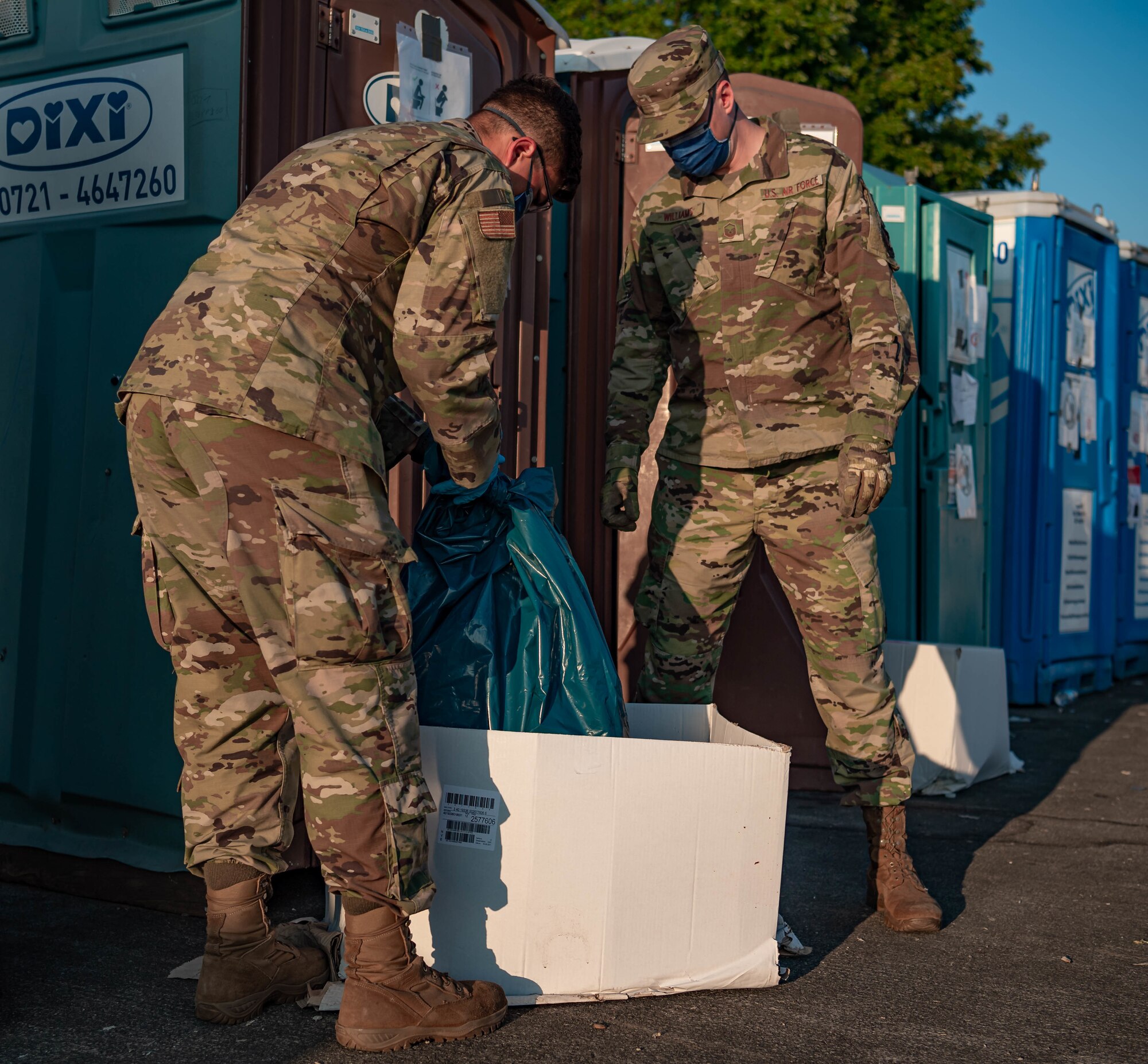 Airmen clean out portable water closets.