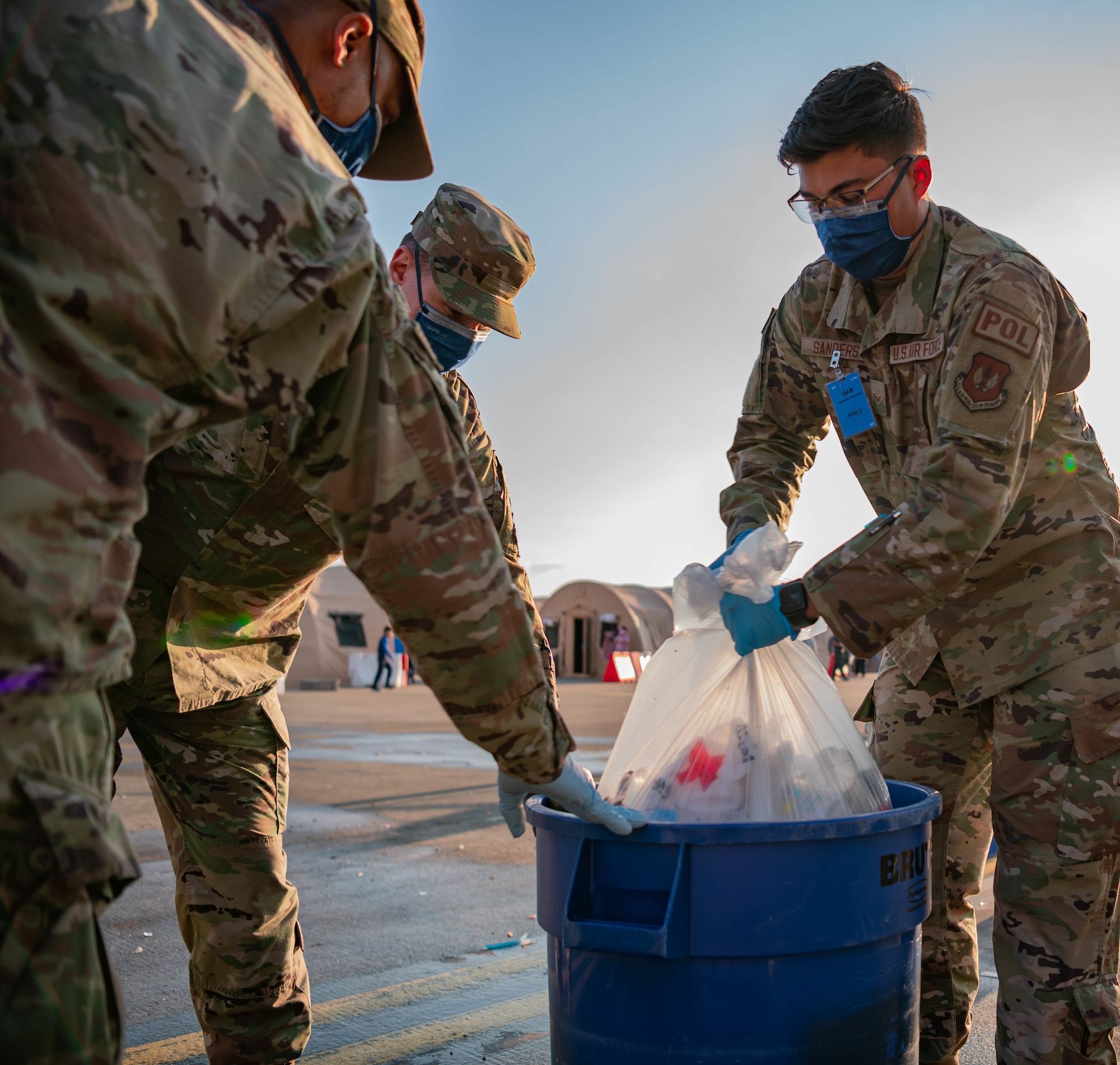 Airmen gather trash.