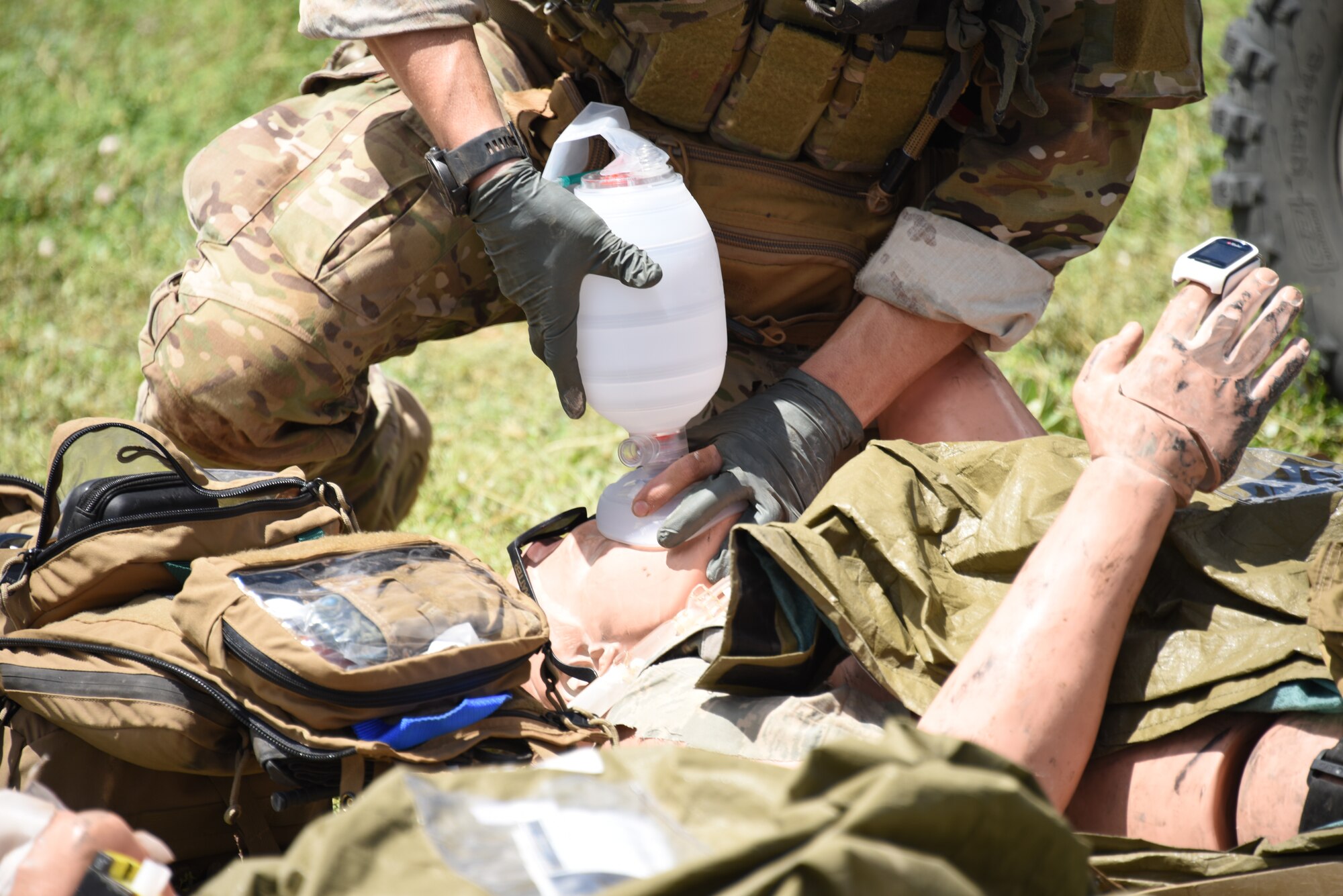 A photo of a pararescueman operating on a simulated injured victim.