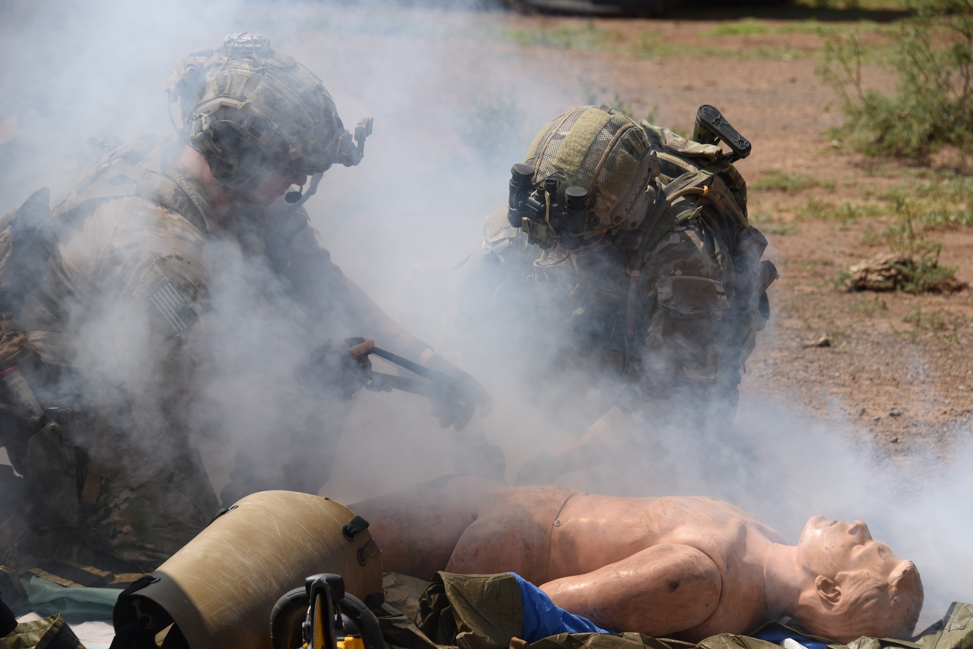 A photo of pararescuemen operating on a simulated injured victim.
