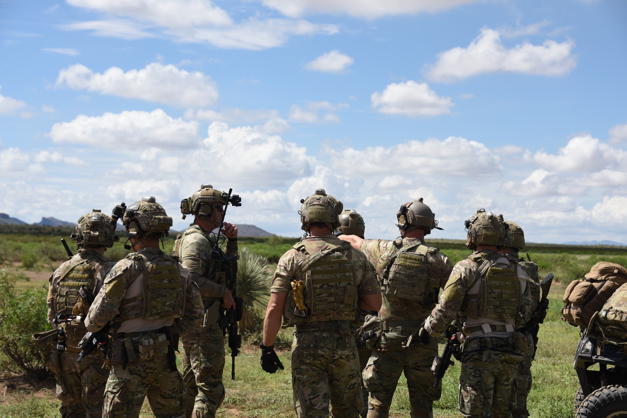 A photo of pararescuemen working together on a strategy.