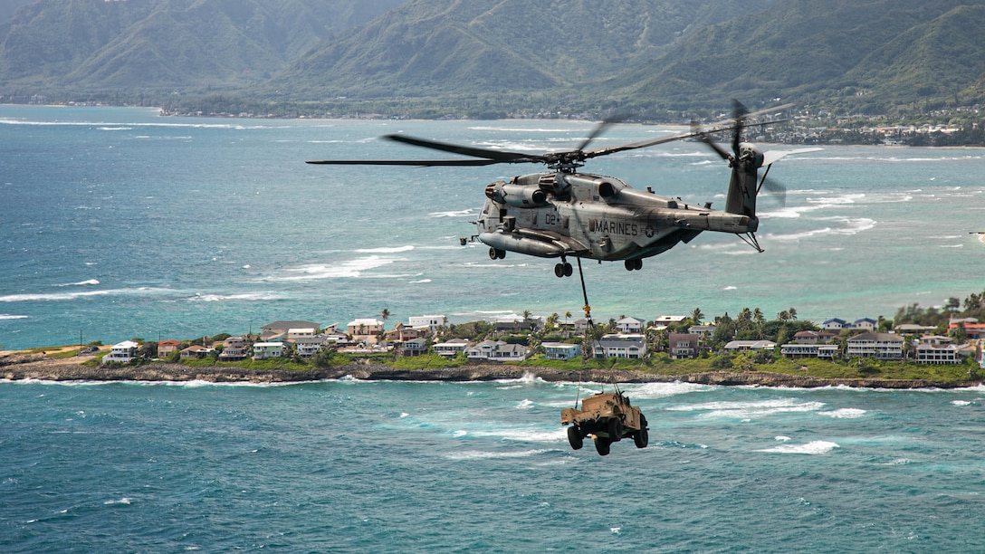 A CH-53E Super Stallion helicopter assigned to Marine Heavy Helicopter Squadron 463 hoists a Joint Light Tactical Vehicle during hoist operations training on Marine Corps Base Hawaii, Sept. 2, 2021. Hoist operations were conducted in order to train landing support specialist and pilots to transfer heavy equipment and supplies from one location to another.