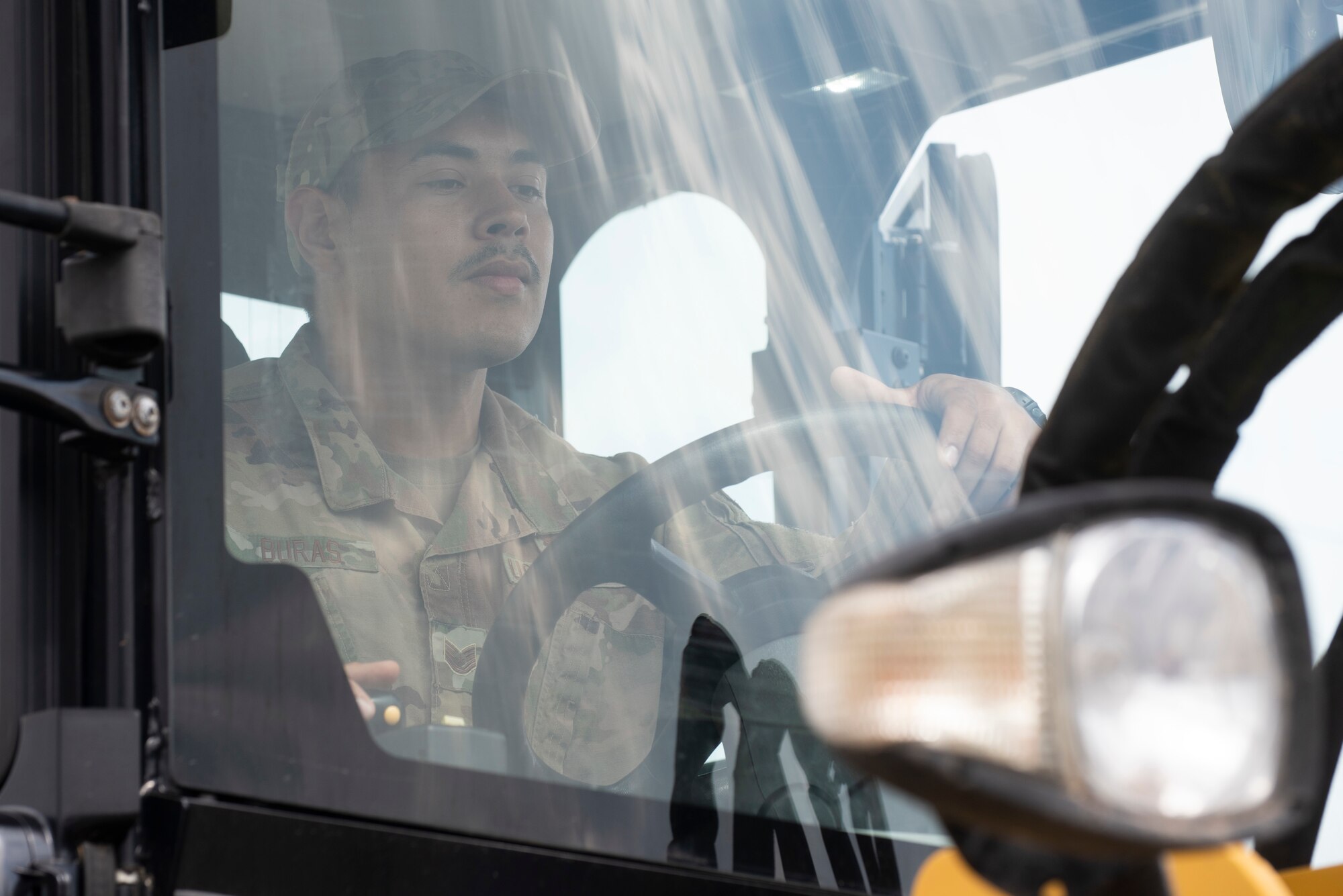 Airman drives construction vehicle.