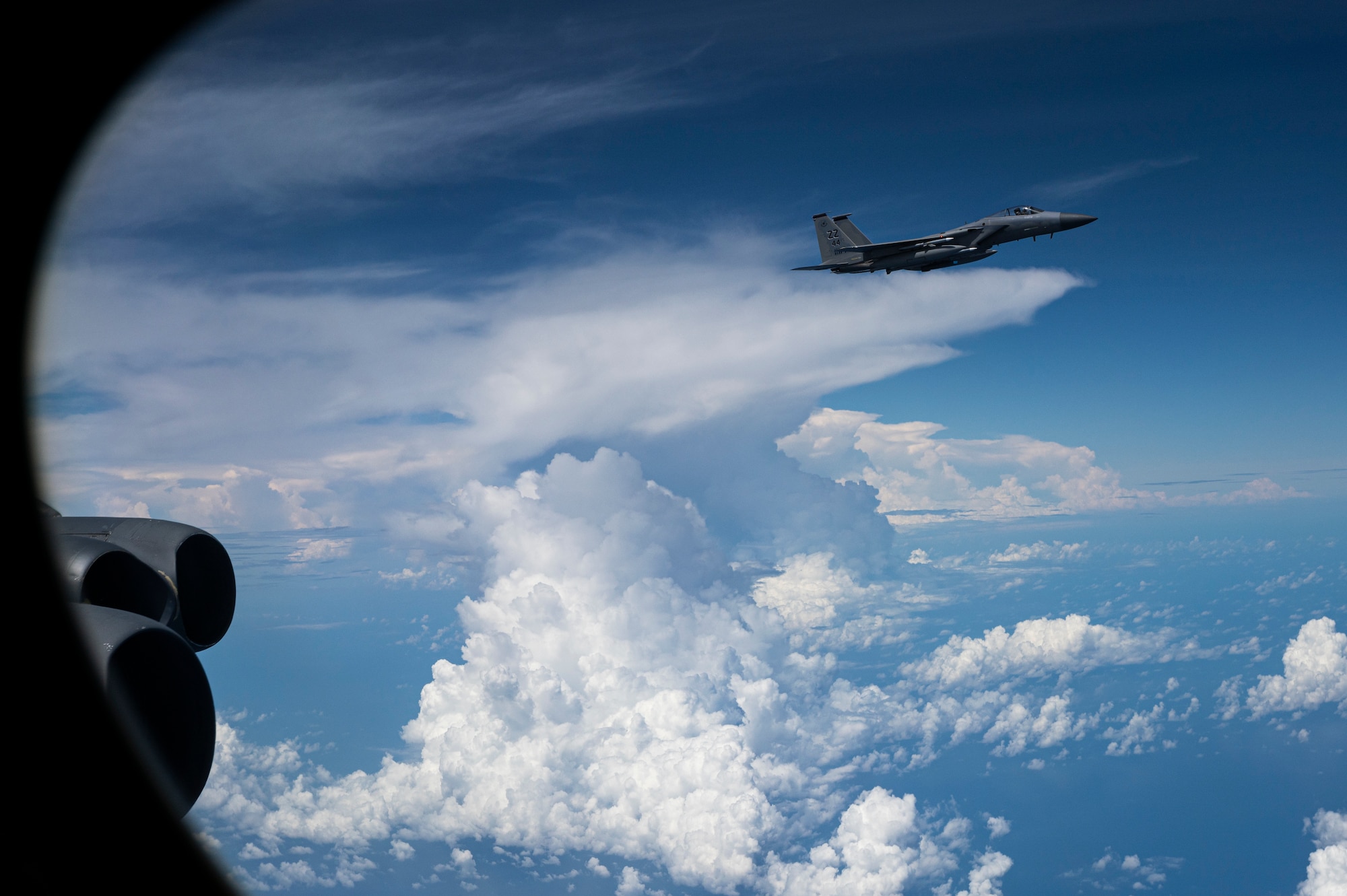 A U.S. Air Force F-15C Eagle, assigned to the 18th Wing, Kadena Air Base, Japan, escorts a U.S. Air Force B-52H Stratofortress, assigned to the 2nd Bomb Wing, Barksdale Air Force Base, Louisiana, during a Bomber Task Force (BTF) mission over the Indo-Pacific region, Sep. 5, 2021. The B-52 is a long-range bomber with a range of approximately 8,800 miles, enabling rapid support of BTF missions or deployments and reinforcing global security and stability. (U.S. Air Force photo by Staff Sgt. Devin M. Rumbaugh)