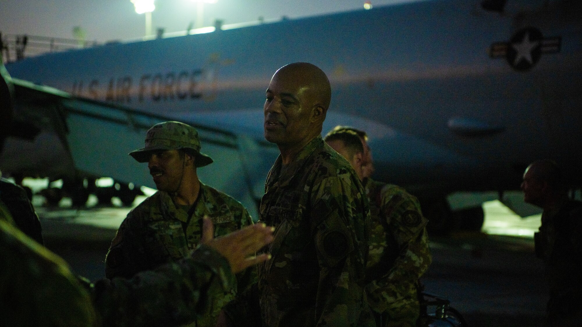 Airmen celebrate next to an E-3 Sentry aircraft