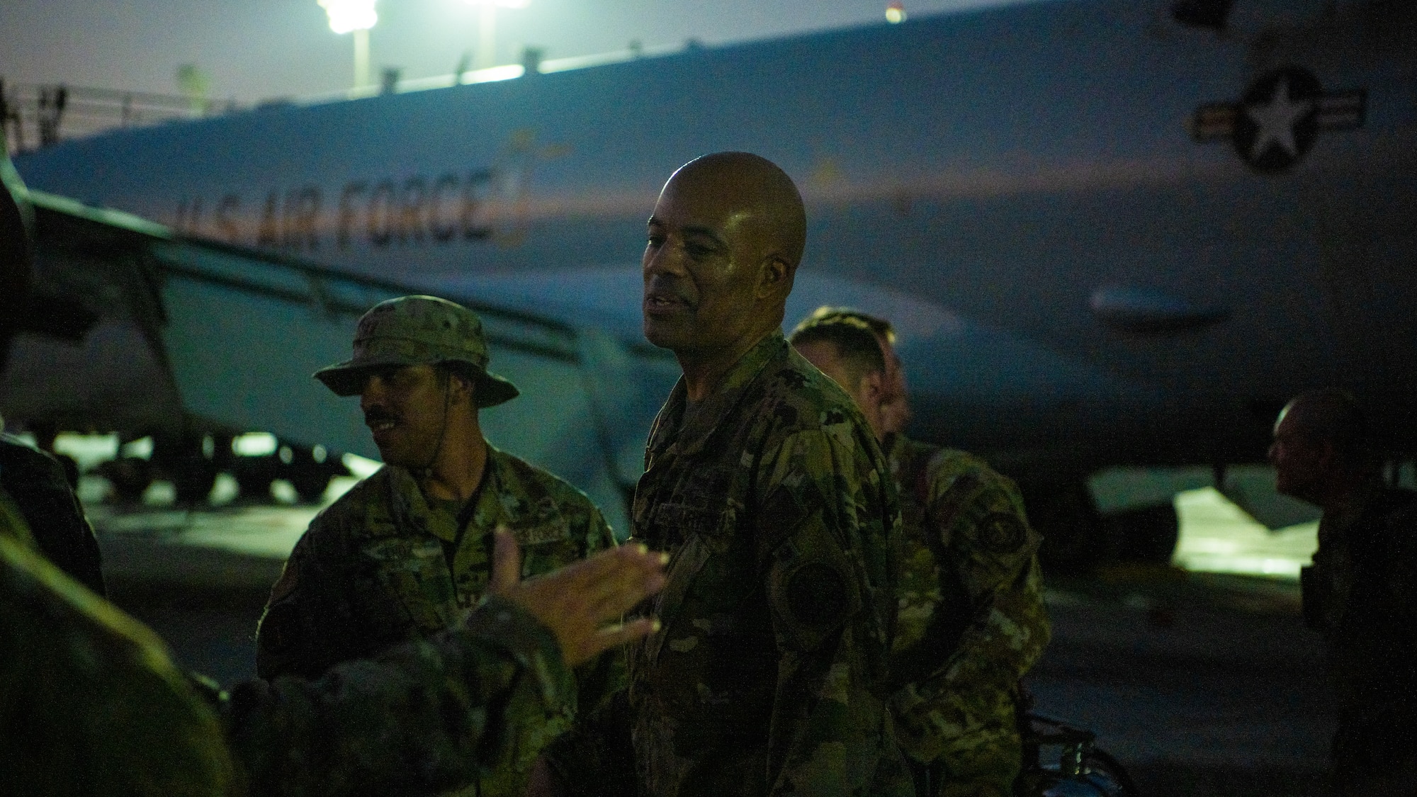 Airmen celebrate next to an E-3 Sentry aircraft