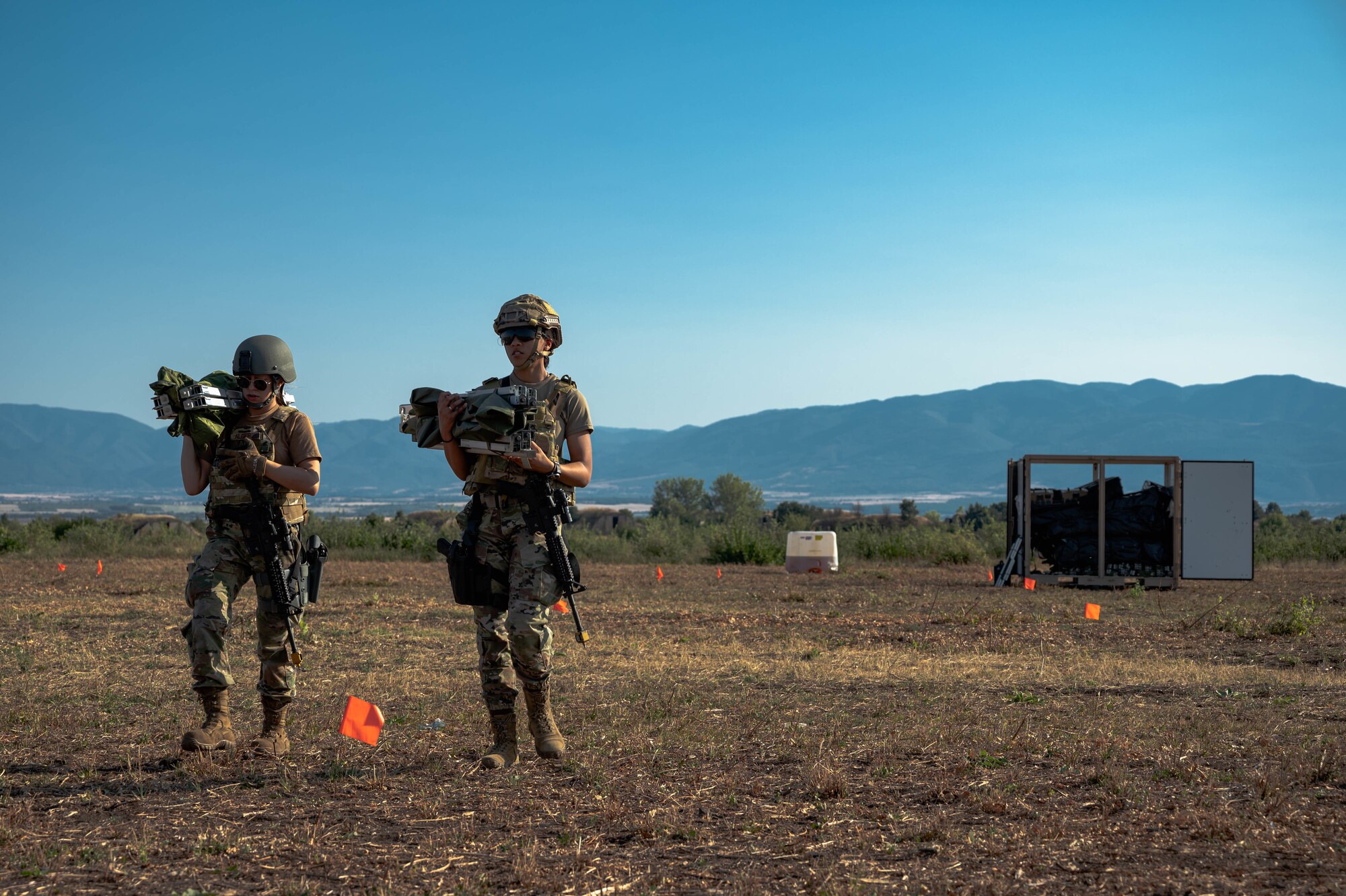 Airmen carry equipment.