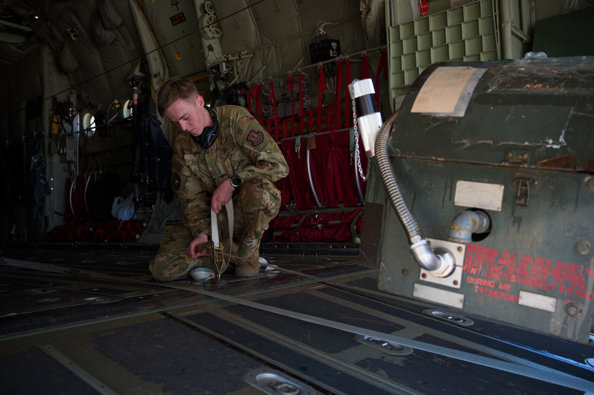 Airman prepares equipment to unload cargo.