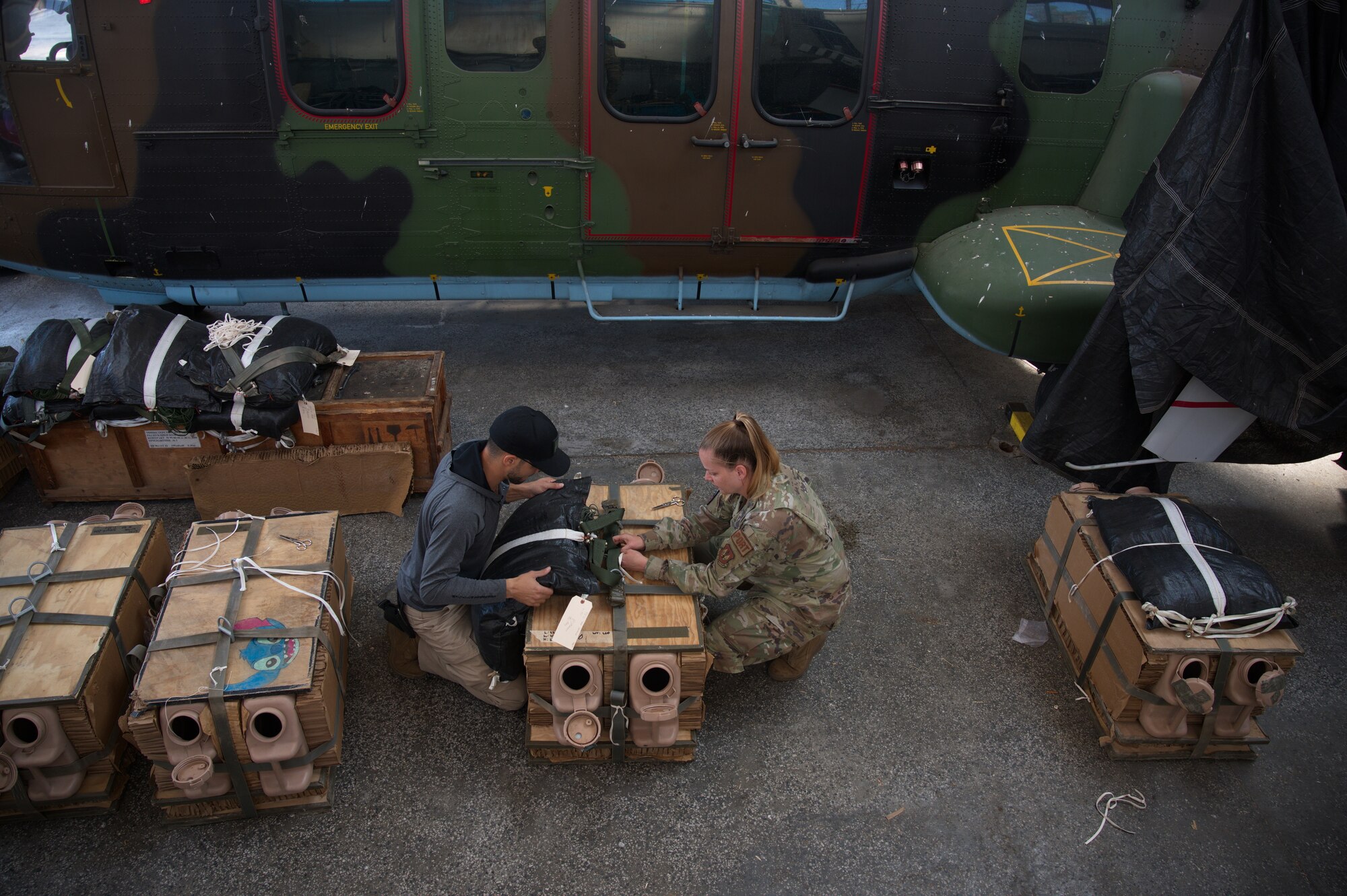 Airmen prepare parachutes.