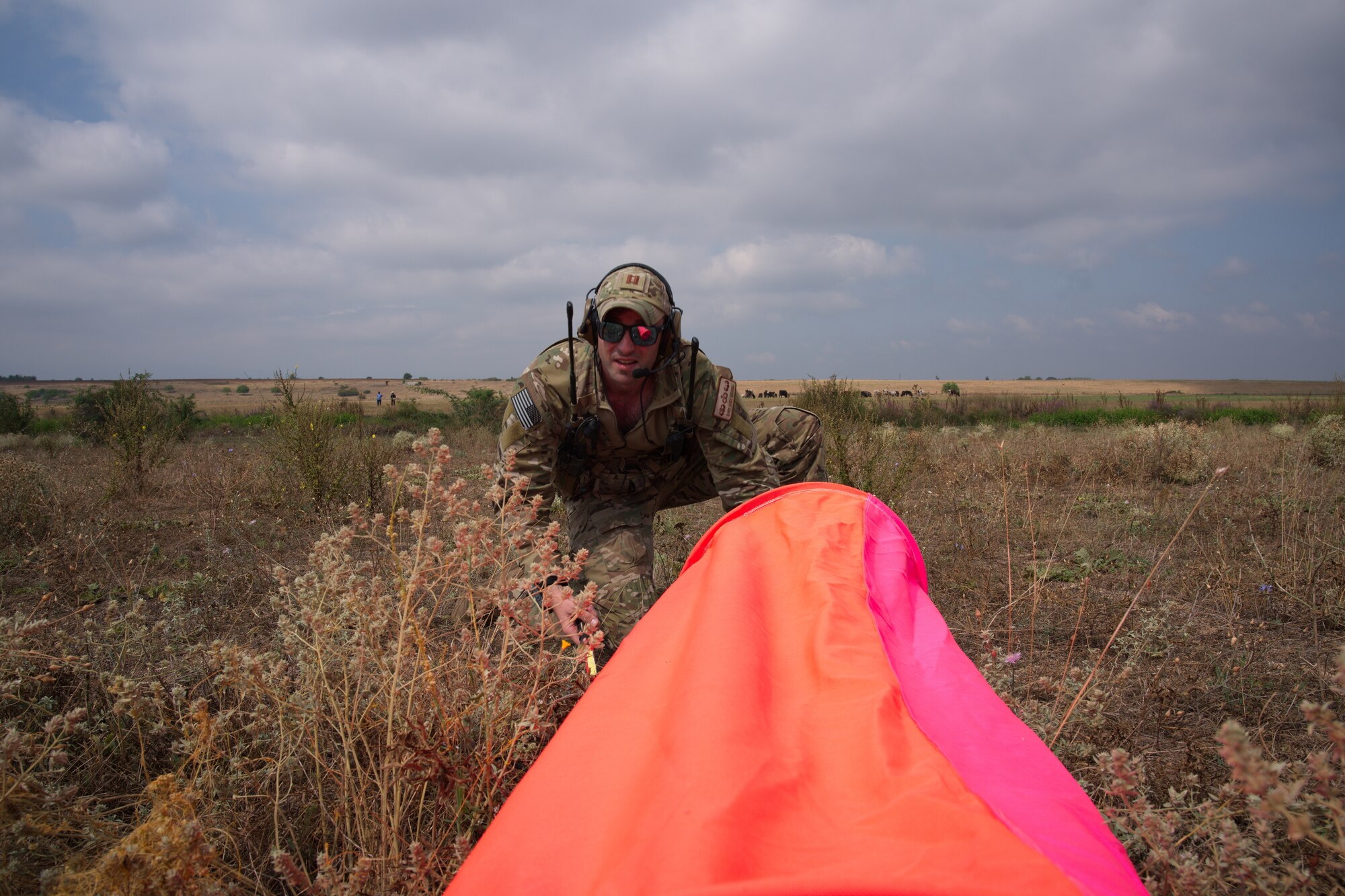 Airman sets-up landing markers for runway.