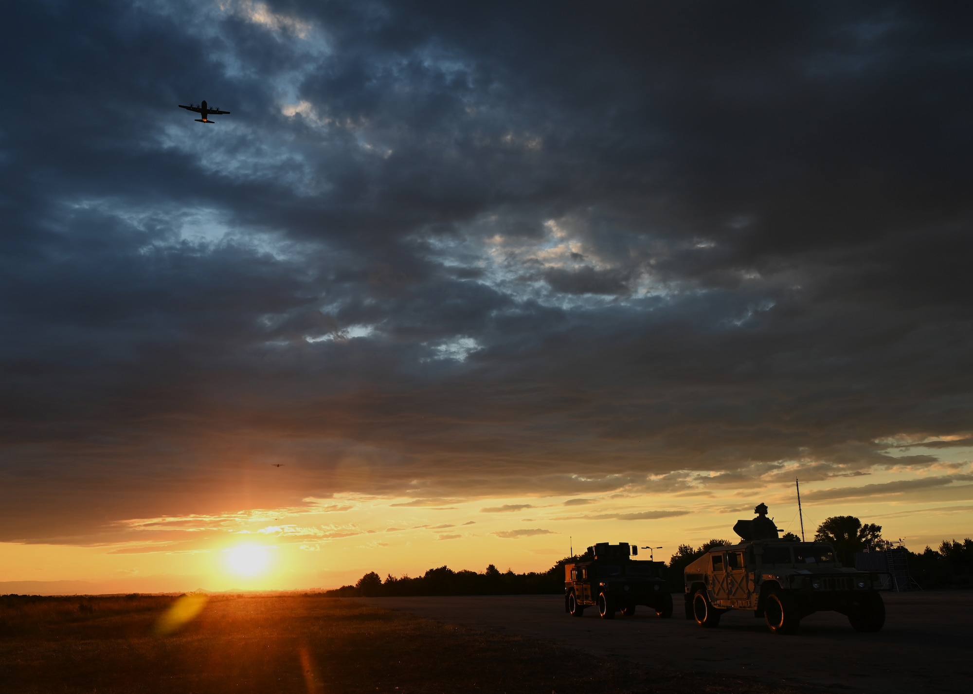 Aircraft flies at sunset.