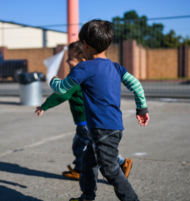 Children play a game outside.