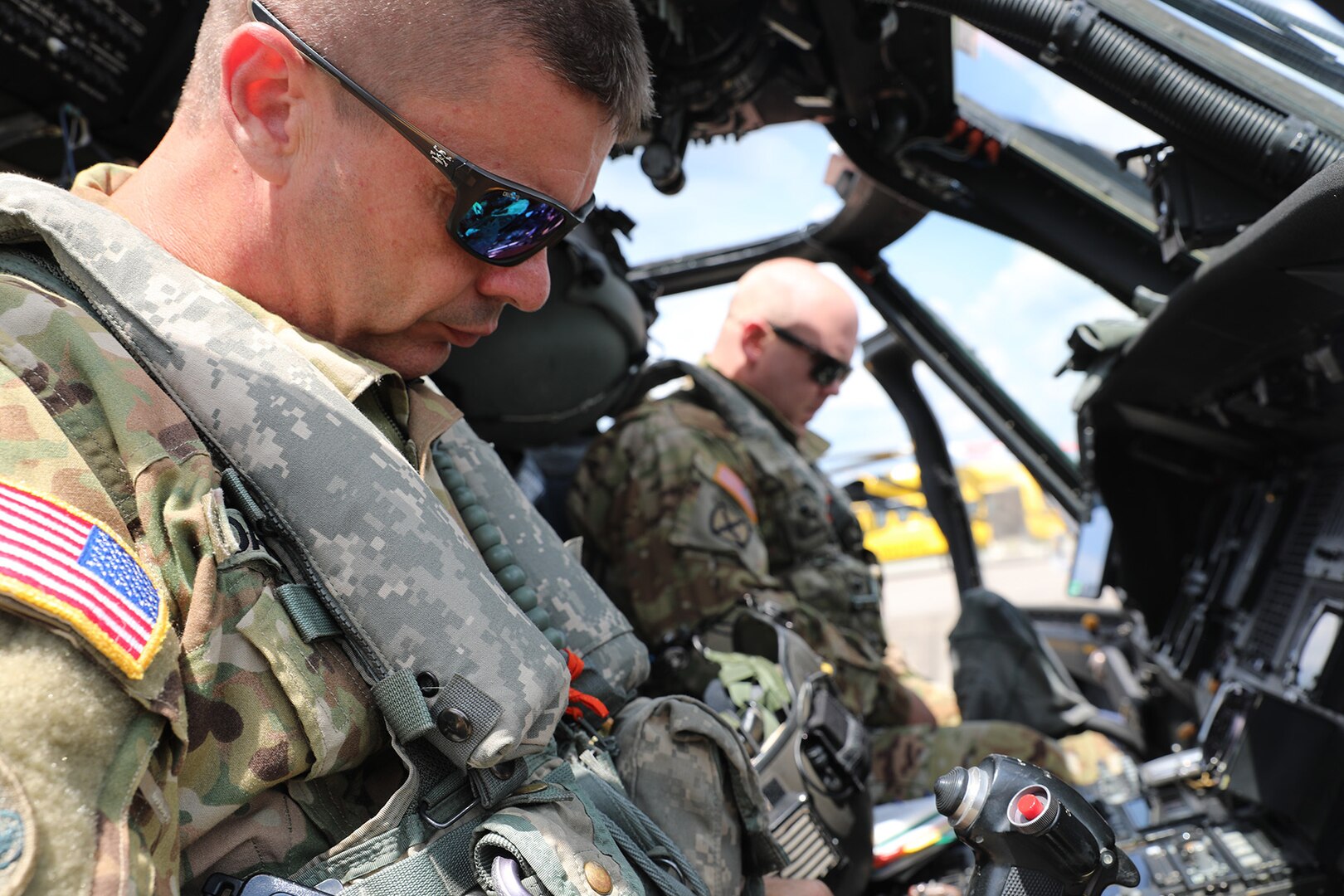 Louisiana National Guardsmen Chief Warrant Officer 3 Cody Davis (left) and Chief Warrant Officer 3 Ronald Cole (right), UH-60 Black Hawk helicopter pilots with the 2-238th General Support Aviation Battalion from Pineville, Louisiana, prepare for search and rescue missions in southeast Louisiana after Hurricane Ida, Sept. 3, 2021.