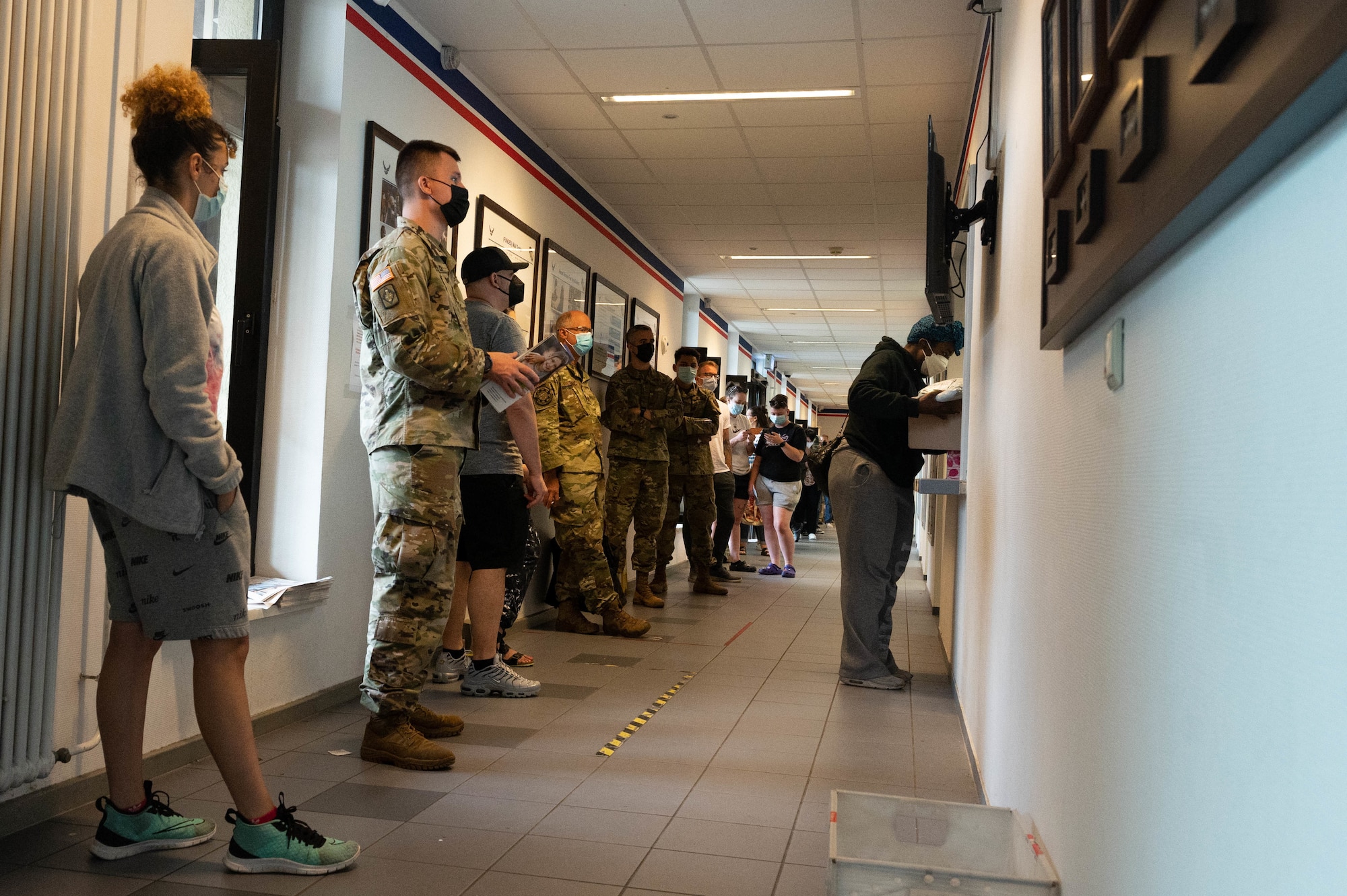 People wait in line to pick up mail.