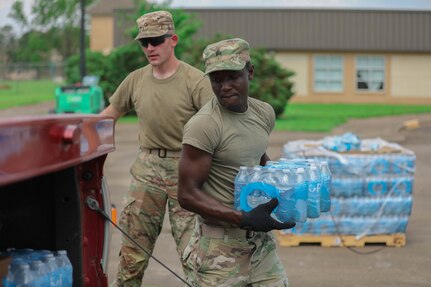 Oklahoma National Guard Sgt. Stephen Bruke hands out water at a point of distribution site in Gramercy, Louisiana, Sept. 4, 2021. The Oklahoma National Guard operates 13 PODs across seven parishes that supply local families with tarps, meals ready to eat, ice and water.