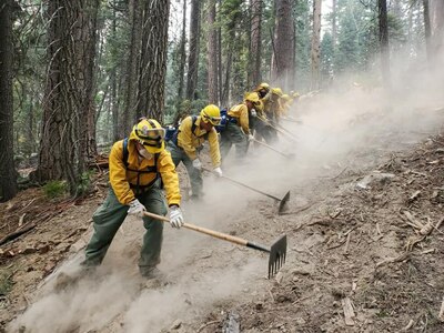A hand crew from the California National Guard's Joint Task Force 578 fights the Dixie Fire as part of the mutual aid system in support of Cal Fire Aug. 16, 2021, in Northern California.