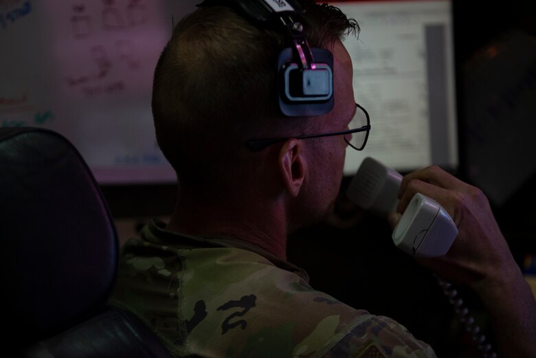 A photo of an Airman talking into a phone